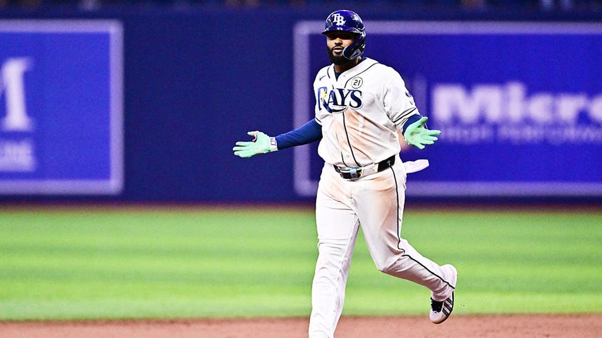 Junior Caminero #13 celebrates after hitting a walk-off home run at Tropicana Field.