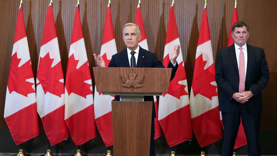 Canadian Prime Minister Mark Carney speaks at a podium during a news conference on U.S.-Canada trade negotiations