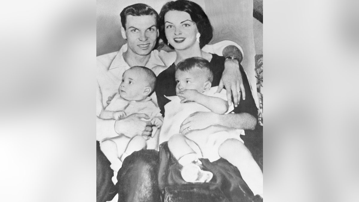 Mary Leona Gage with her husband and two sons in a black and white photo.