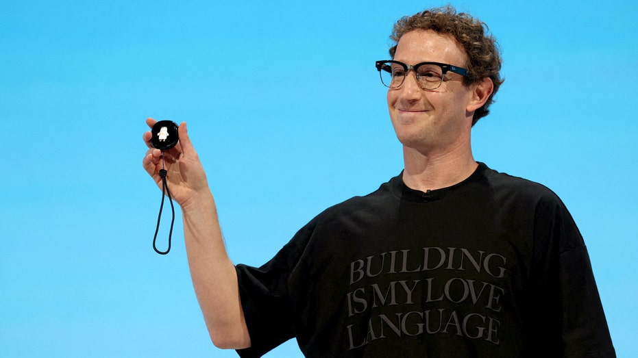Meta CEO Mark Zuckerberg holds a Muse charm.