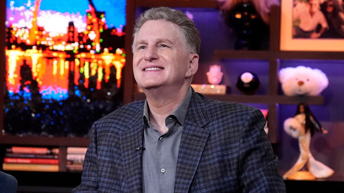 Michael Rapaport wearing a suit and looking forward