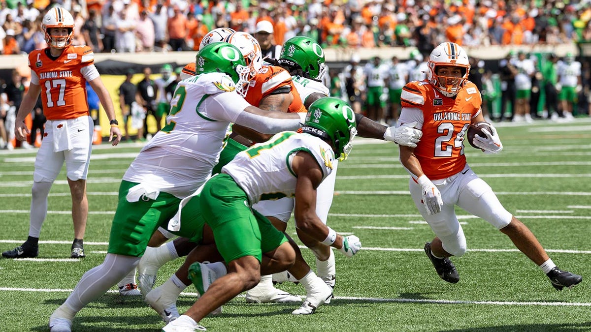 Oklahoma State football player running with the ball