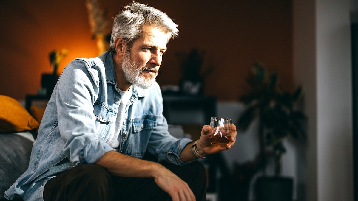 Older man drinking alone