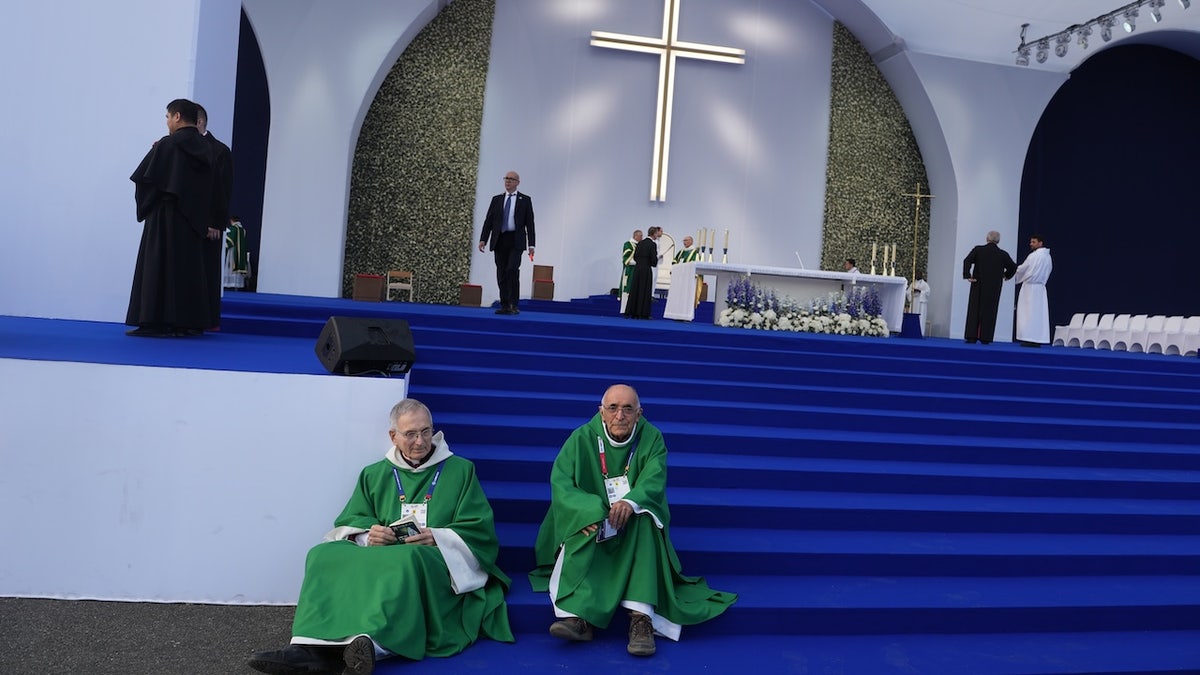 Priests sit before a Mass celebrated by Pope Leo XIV at the Sanctuary of Our Lady of Lourdes, France Sunday, Sept. 27, 2026.