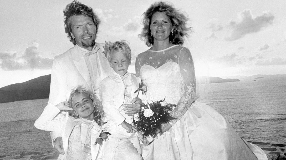 Richard Branson and Joan Templeman stand with Holly and Sam after their wedding on Necker Island.