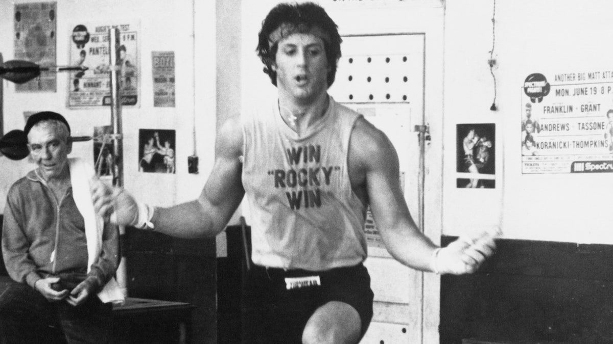 Training for a heavy weight title fight, Rocky Balboa (Sylvester Stallone) skips rope under the watchful eye of his manager, Mickey (Burgess Meredith), and trainer Johnny (Stuart K. Robinson) in Rocky II. (Photo by �� John Springer Collection/CORBIS/Corbis via Getty Images)