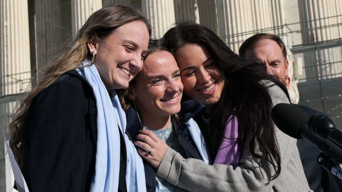 Female athletes speak outside the US Supreme Court after justices heard arguments in challenges to state bans on transgender athletes in women's sports on January 13, 2026, in Washington, DC.