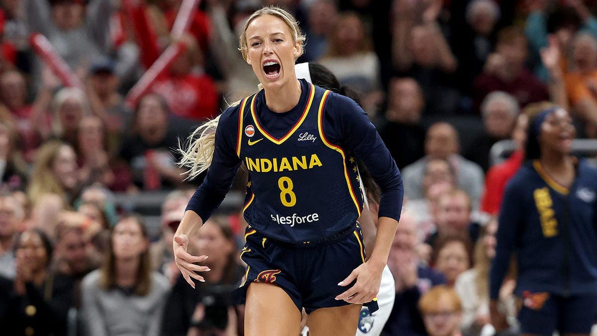 Sophie Cunningham celebrates after making a three-point shot for the Indiana Fever.