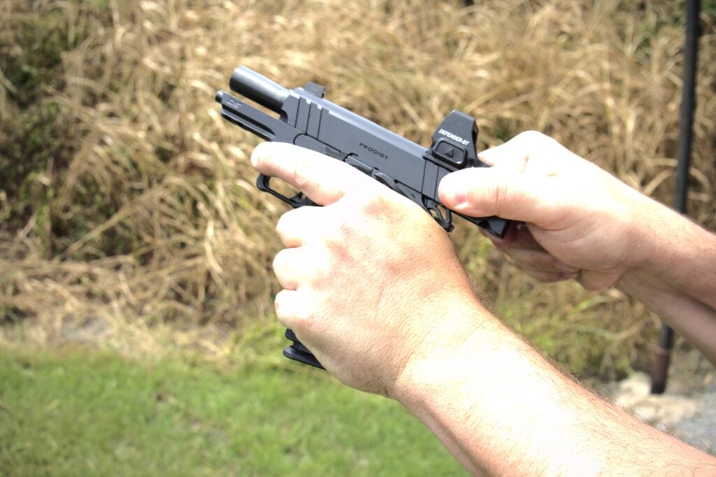 manipulating the slide of the Springfield Prodigy pistol