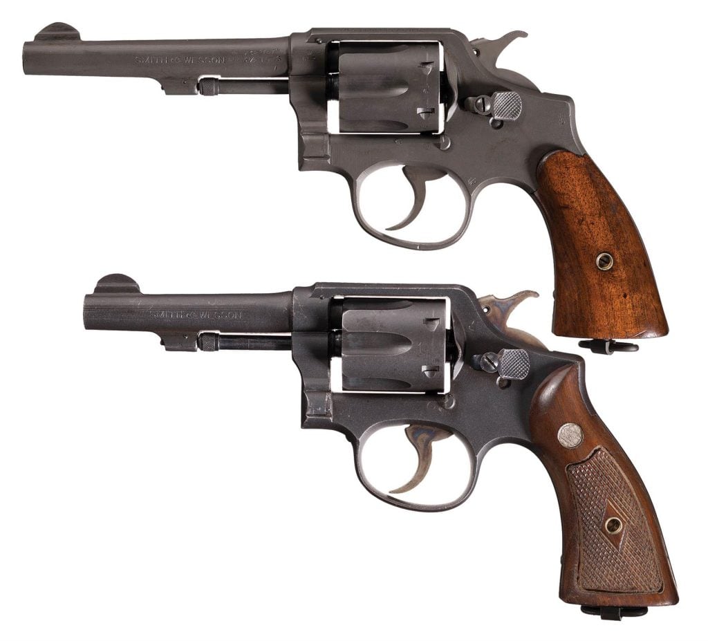 Two revolvers with wooden grips and iron sights, displayed side by side. Old smith and wesson .38s on auction