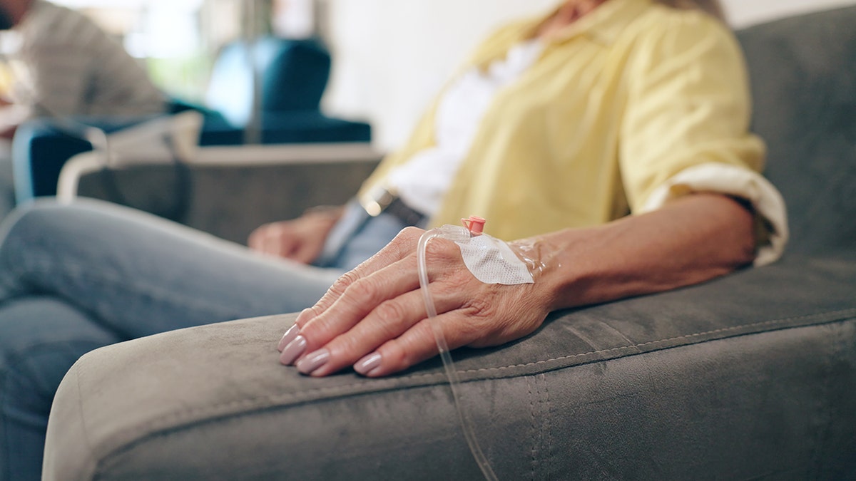 A woman with an IV drip in a hospital.
