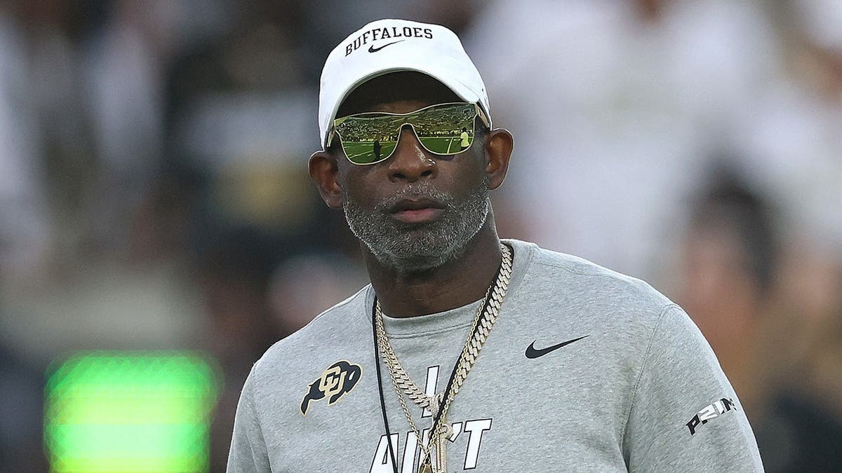 Deion Sanders looks on during warmups at Bobby Dodd Stadium.