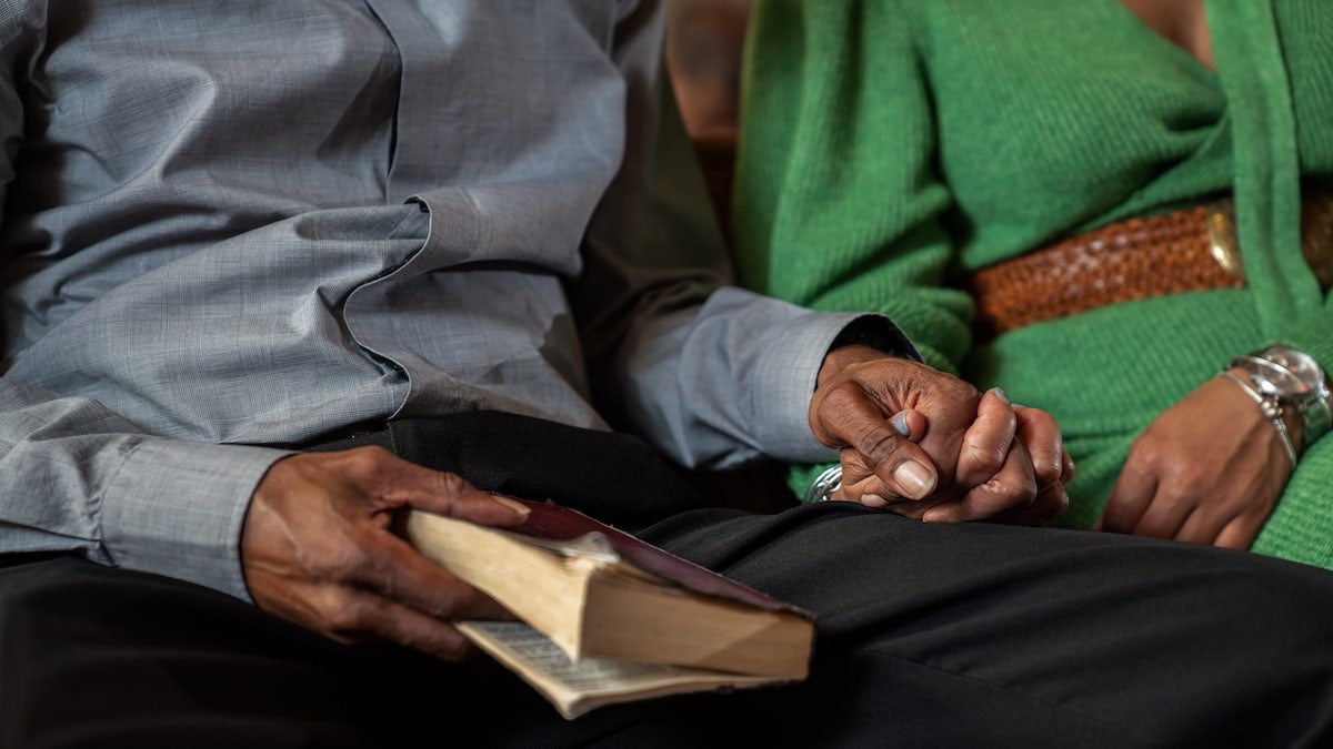 Couple holding hands at church