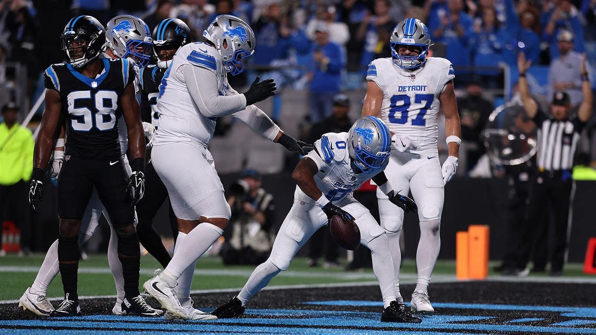 Jahmyr Gibbs celebrates with teammates after a touchdown in Charlotte.