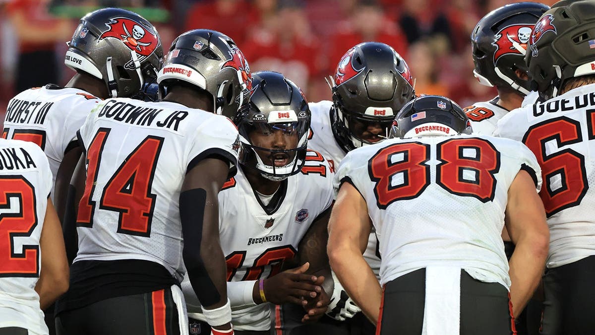 Jalon Daniels huddles with teammates during a game at Raymond James Stadium.