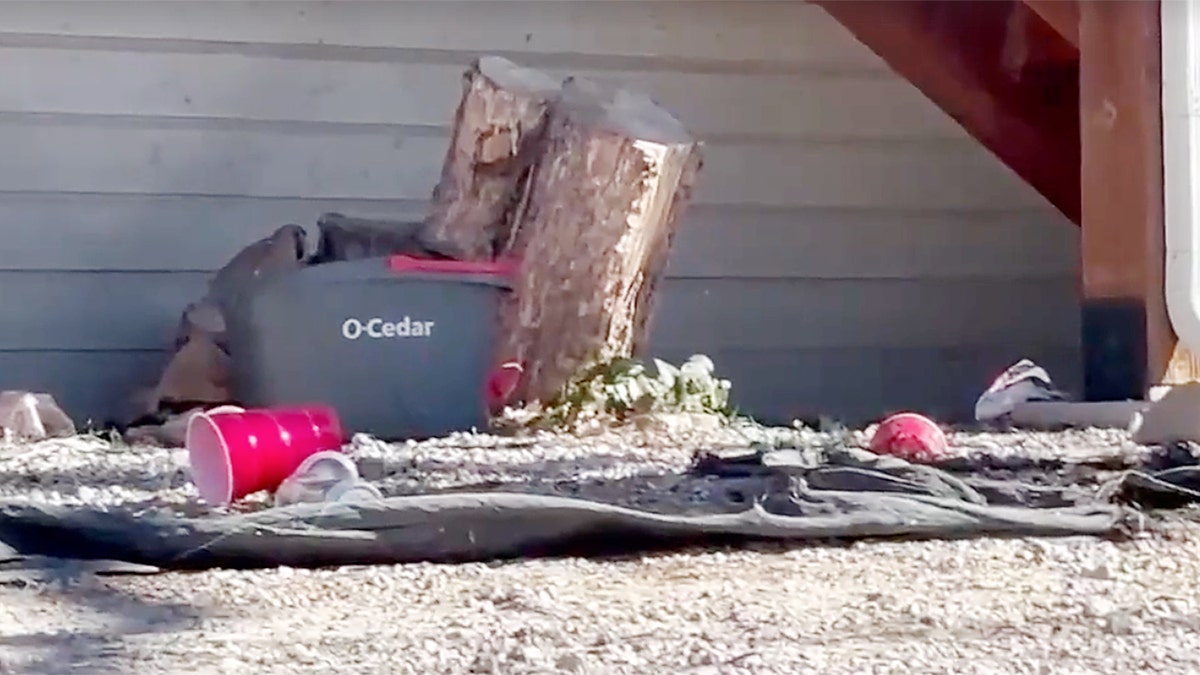 Red plastic cups and debris outside a residence near Northern Arizona University following a fraternity hazing investigation