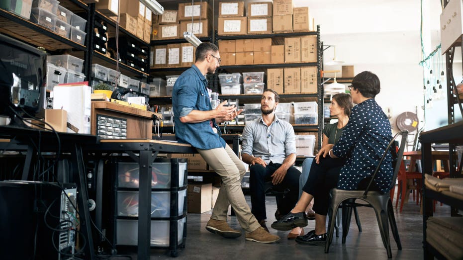 Workers gather at a small business.
