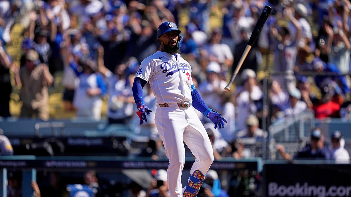 Teoscar Hernández celebrates after hitting a two-run home run during a baseball game.